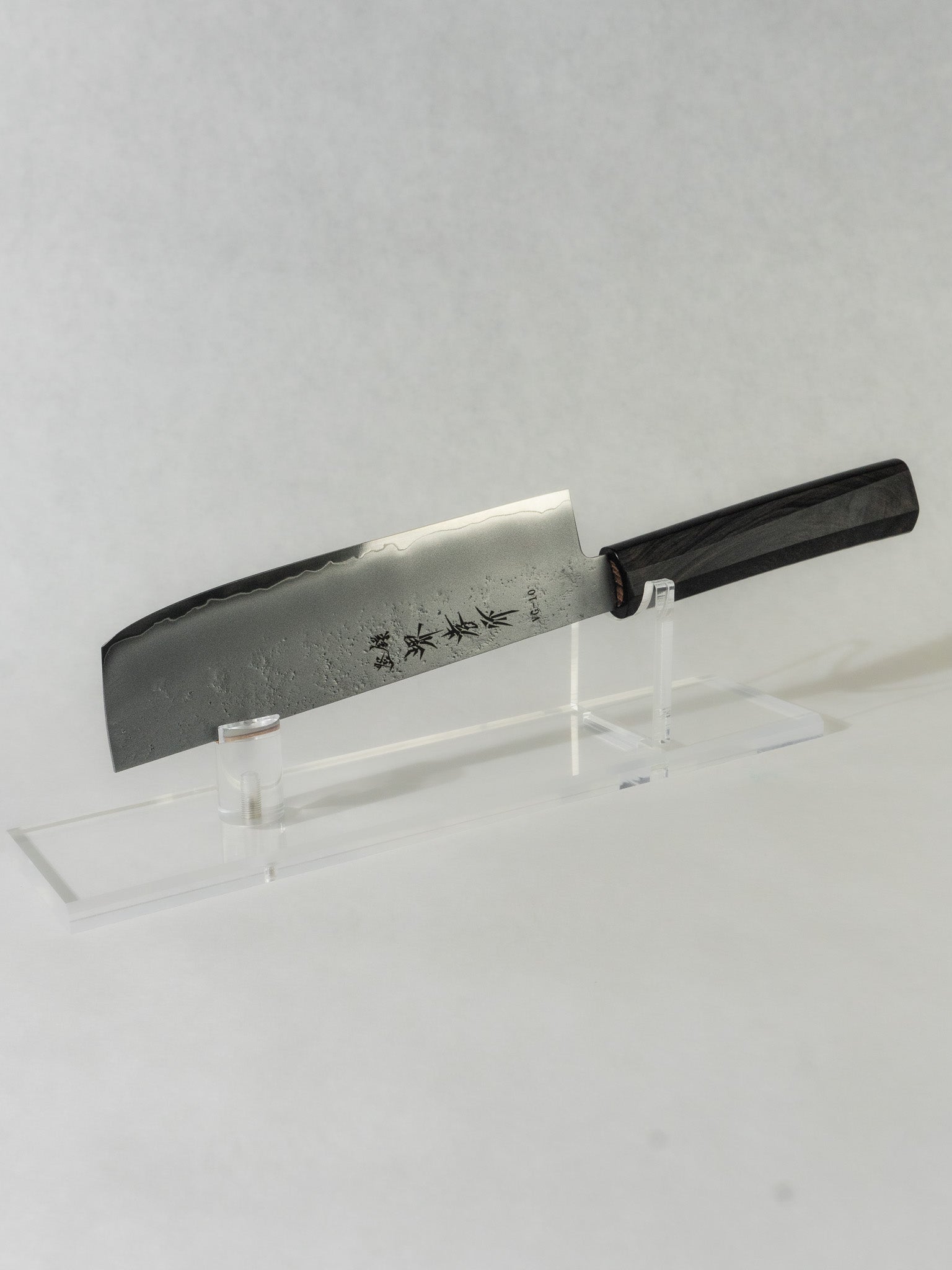 Sakai Takayuki nakiri knife with a delicate hammered blade finish that improves food release, paired with an octagonal ebony wood handle for excellent balance, control, and a refined feel in hand.