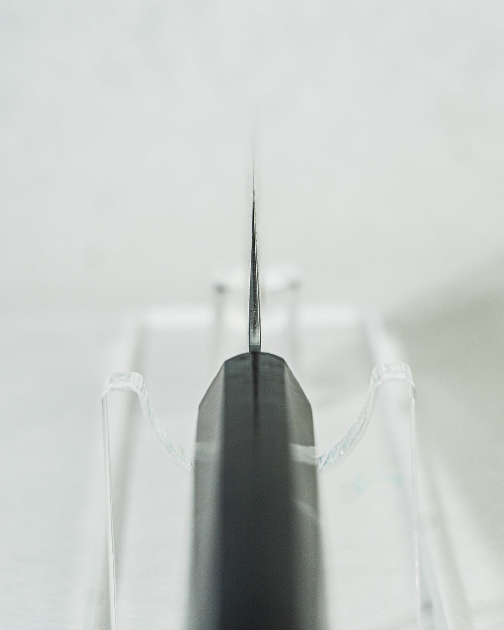 Sakai Takayuki nakiri knife highlighting a close-up view of the octagonal ebony wood handle, choil detail, and the blade’s balanced profile.