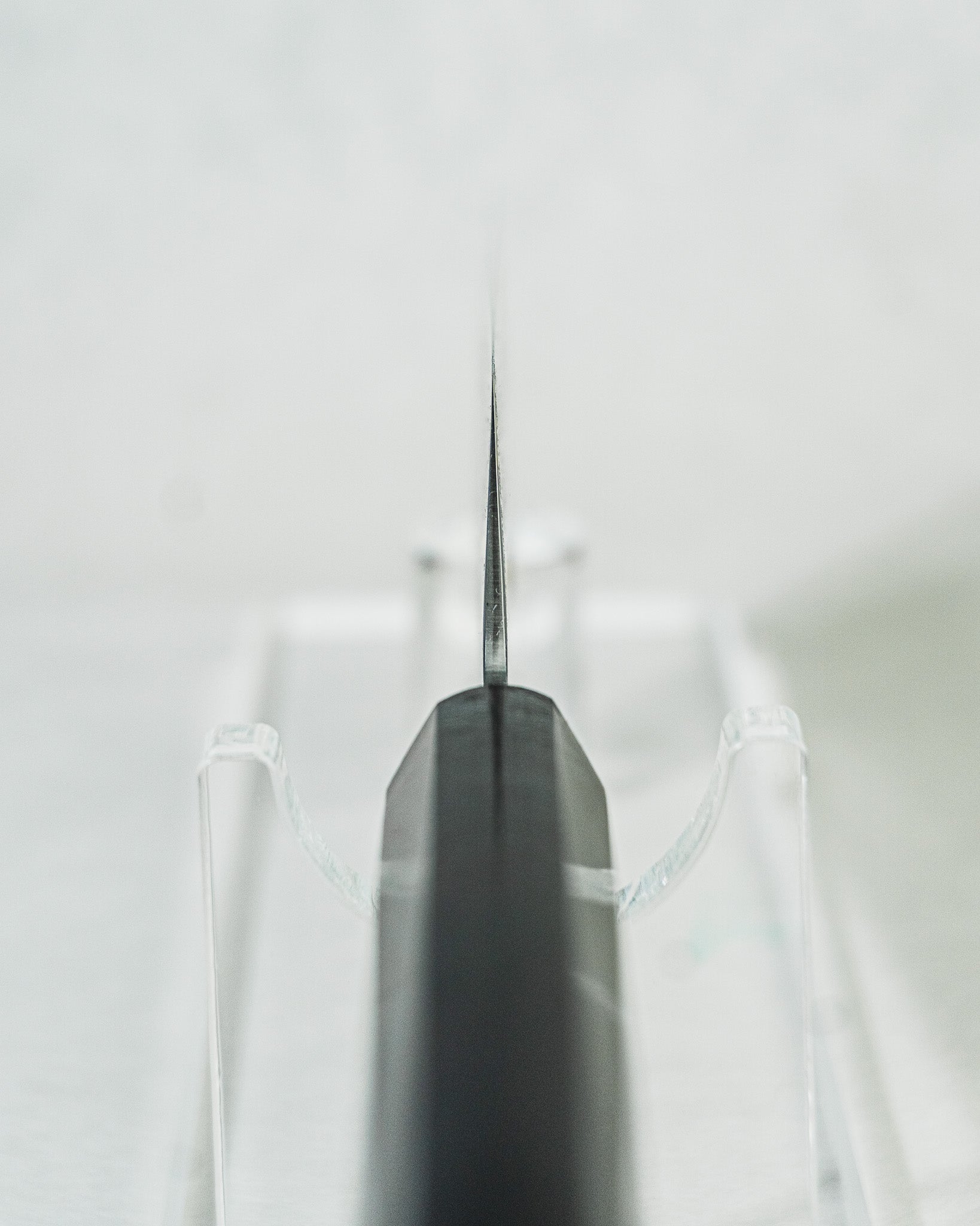 Sakai Takayuki nakiri knife highlighting a close-up view of the octagonal ebony wood handle, choil detail, and the blade’s balanced profile.