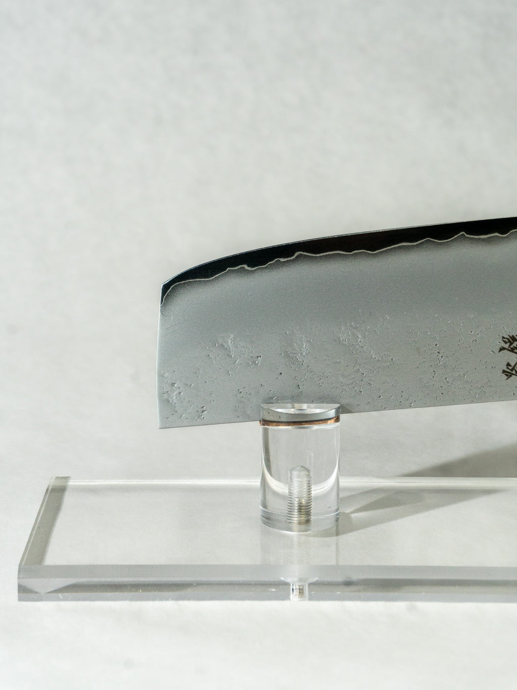 Showing the tip of the nakiri knife, highlighting the beautiful wave-like kasumi patterning along the edge of the blade.