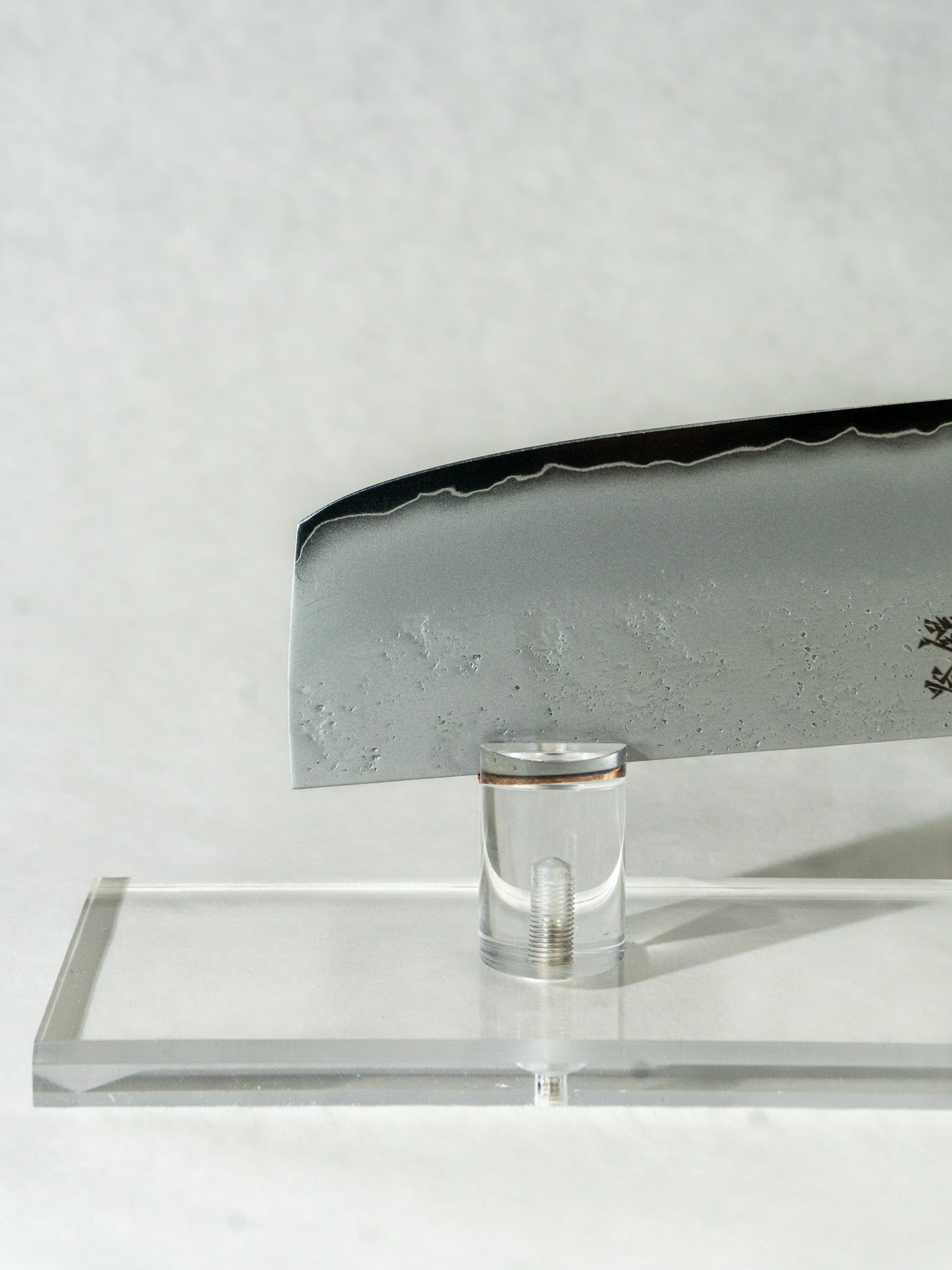 Showing the tip of the nakiri knife, highlighting the beautiful wave-like kasumi patterning along the edge of the blade.