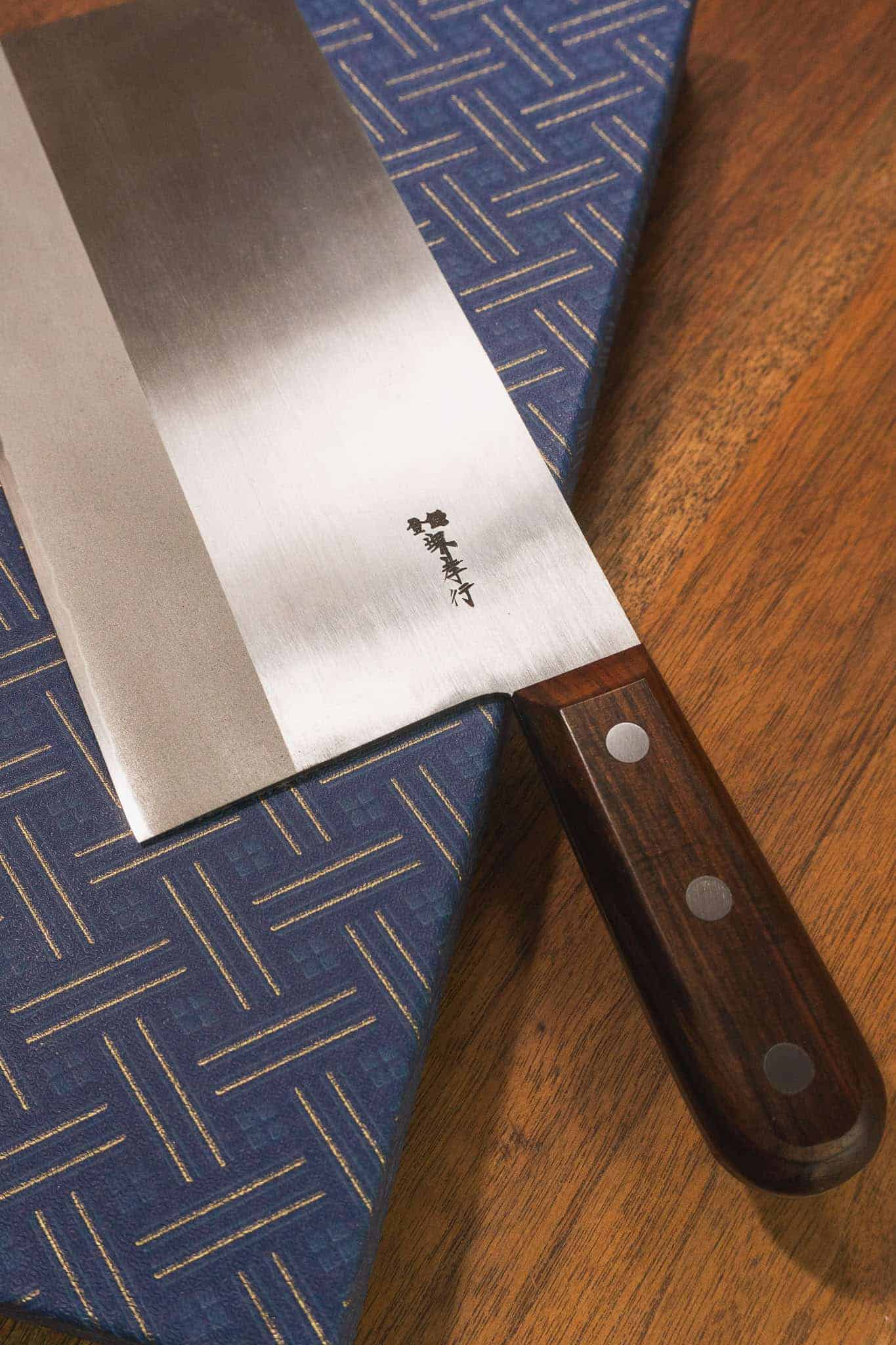 Close up of the maker's mark stamp on the cleaver. Made in Sakai City with  Japanese craftsmanship.
