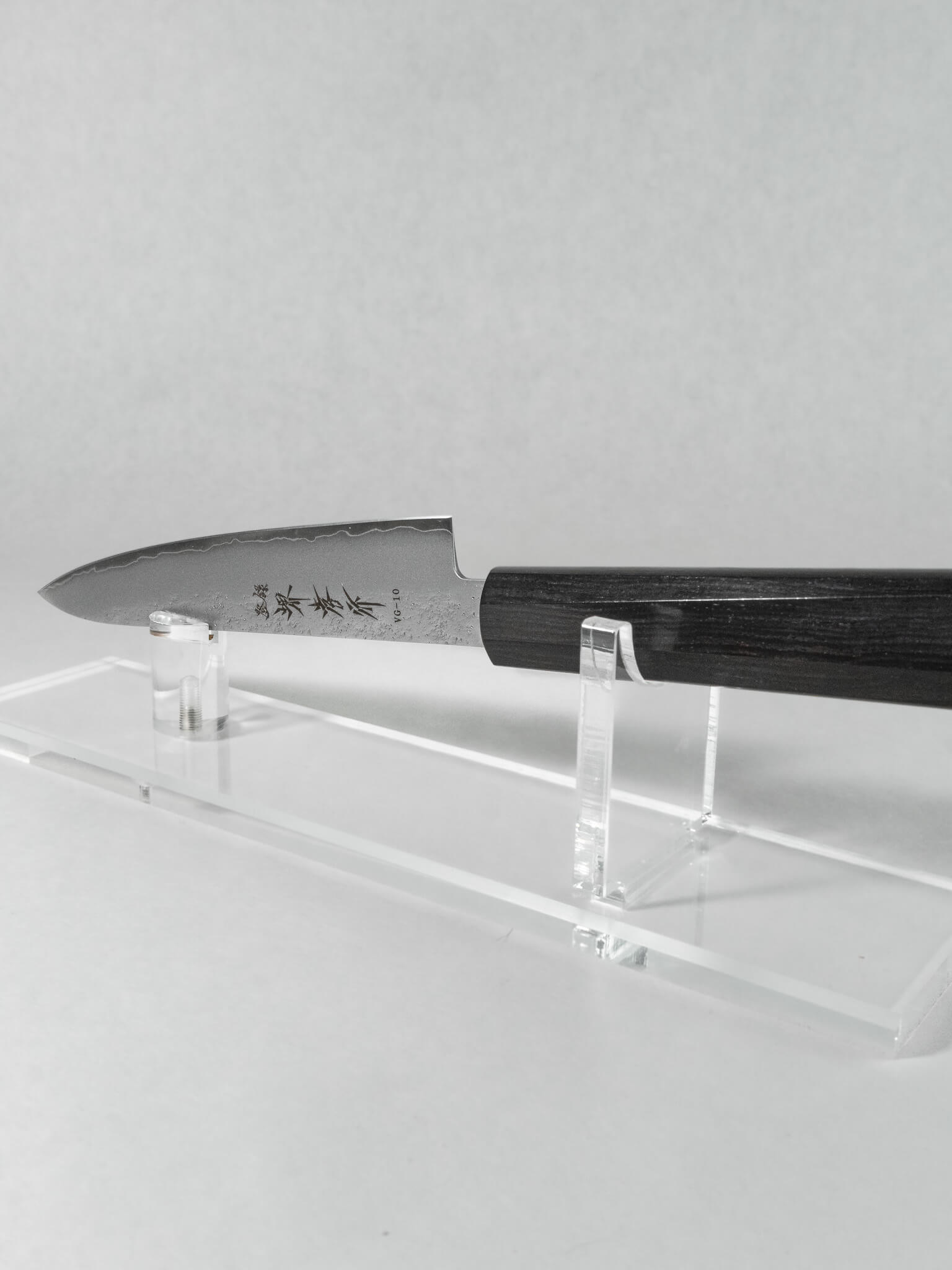 Side profile of Japanese petty knife showing slim, pointed blade