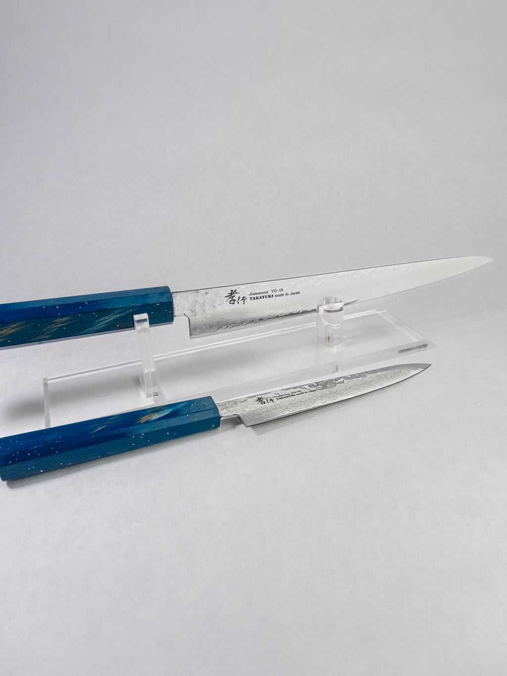 Premium Japanese Sujihiki knife for fish and meat slicing shown along side it's matching petty counterpart.