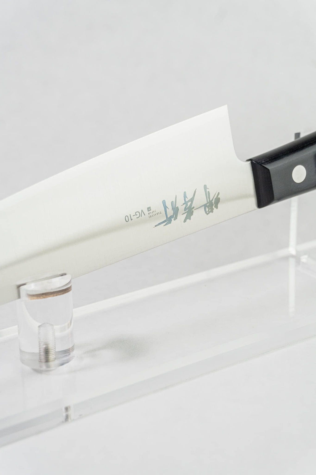 VG-10 stainless steel blade on Sumire Gyuto. Perfect balance point shown on white background