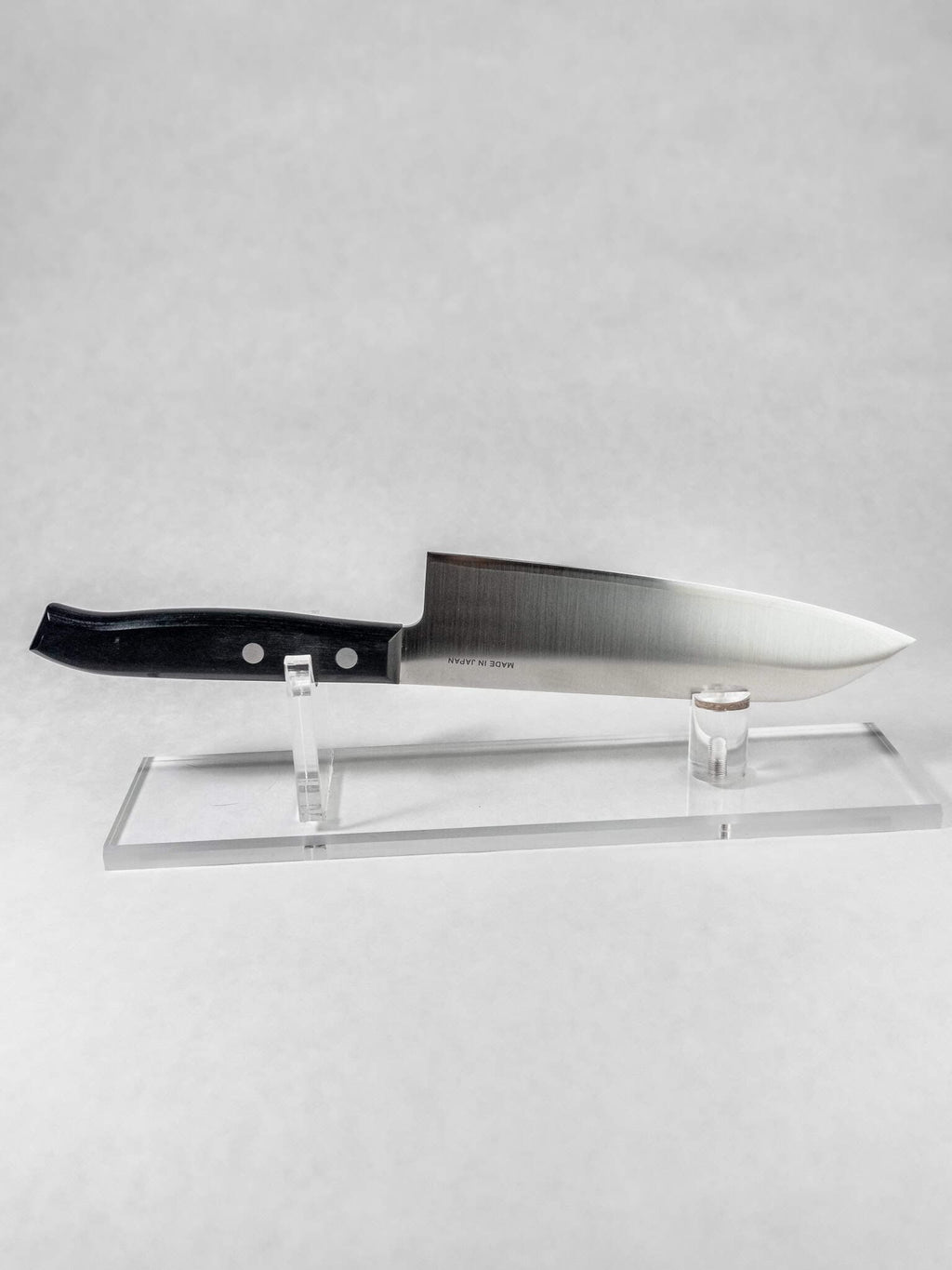 VG-10 stainless steel blade on Sumire Santoku against a white background.