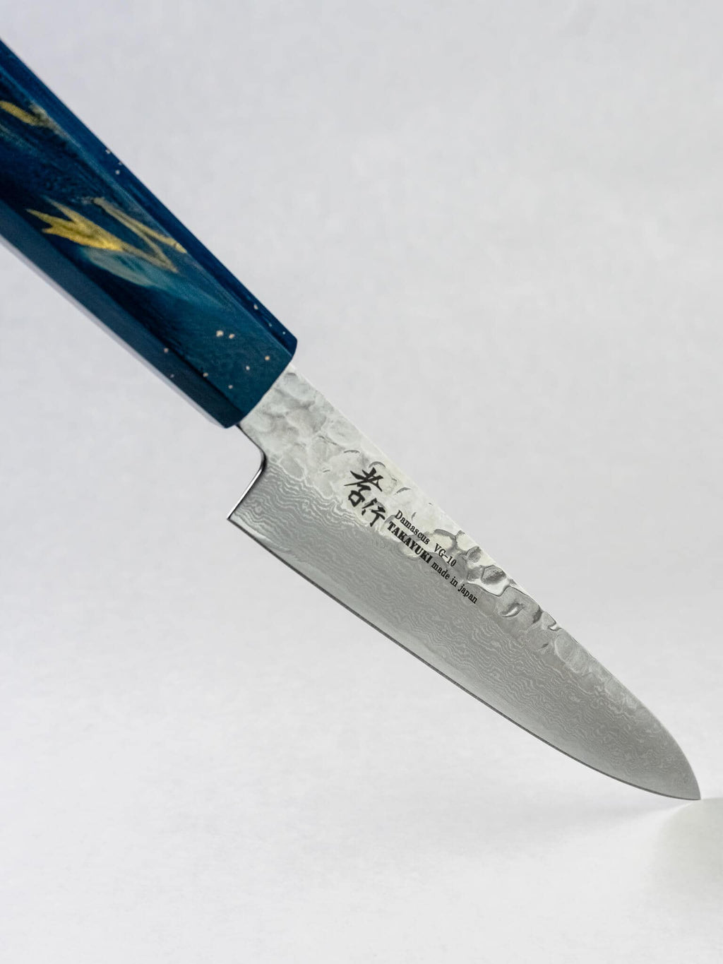 Precision tip detail on VG10 Japanese petty knife displayed against a white background.
