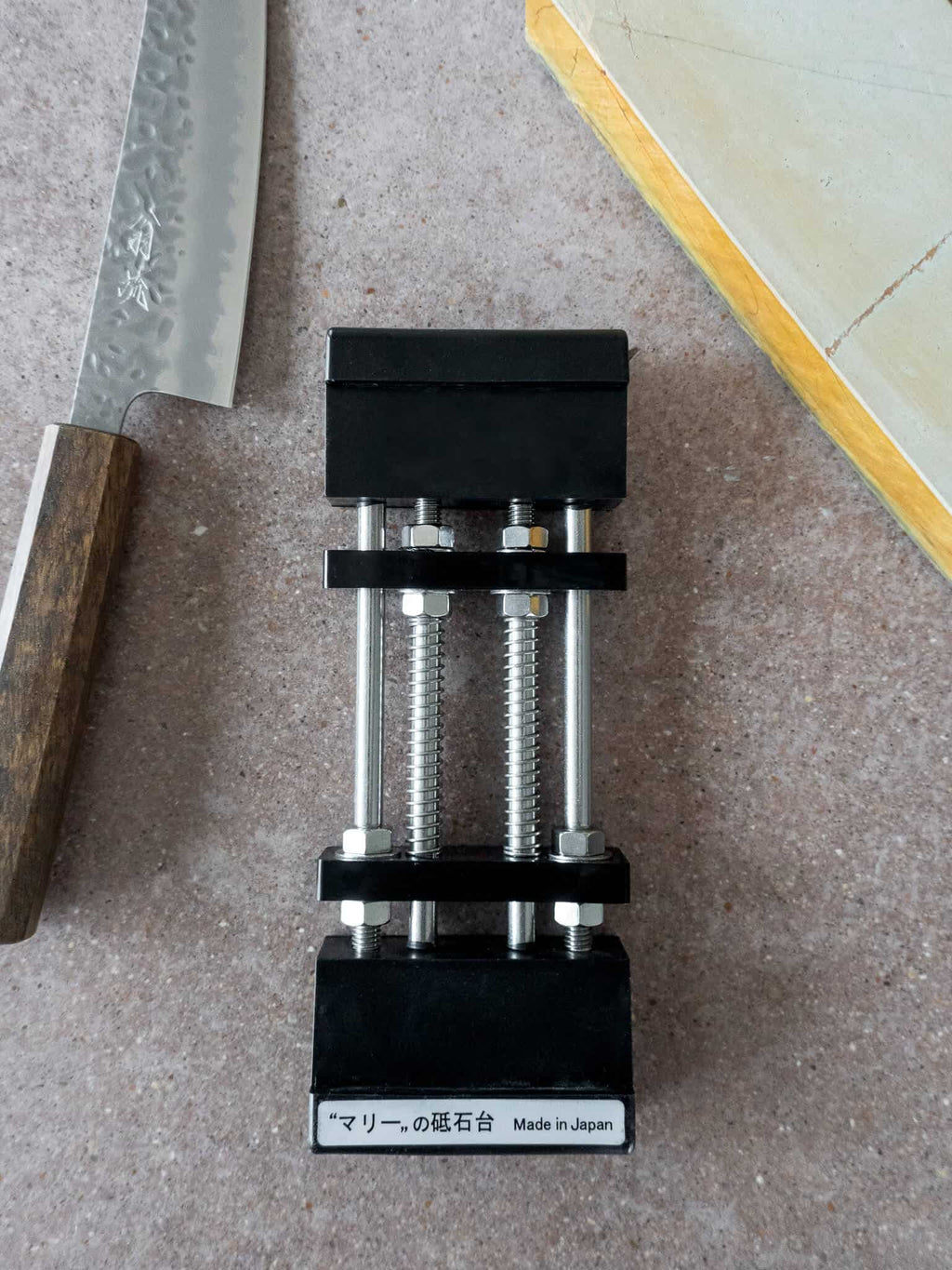 Top view of spring-loaded sharpening stone holder with suction grip