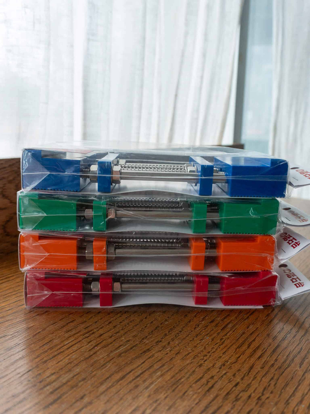 Blue, green, orange and red variations of the sharpening stone holders