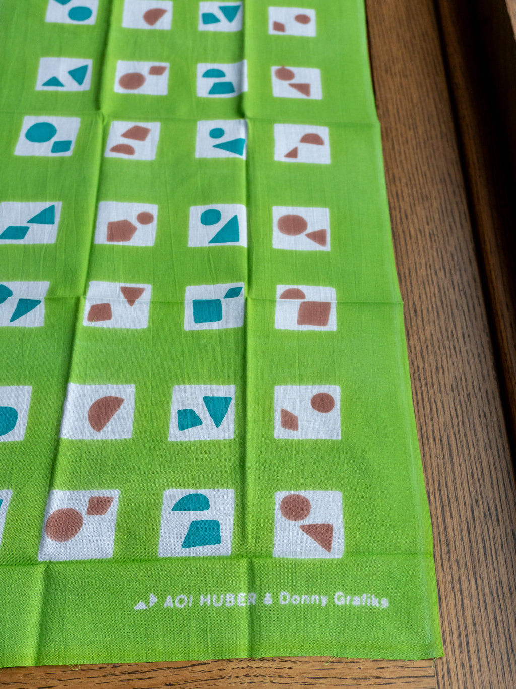 Flat lay of Tenugui hand towel showing length and MADO PRINT design
