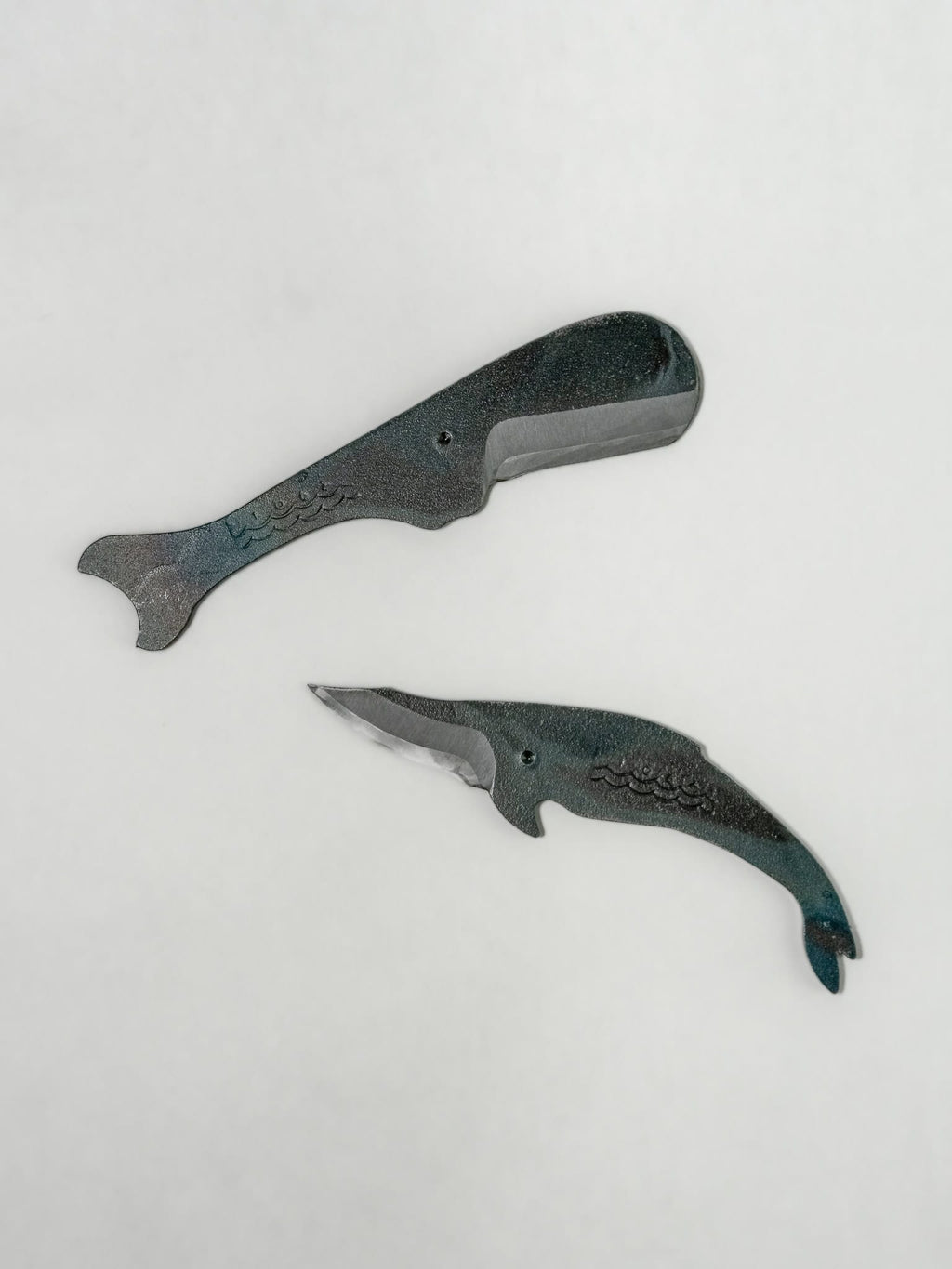 Two whale-shaped Japanese styled utility knife on a light gray background.