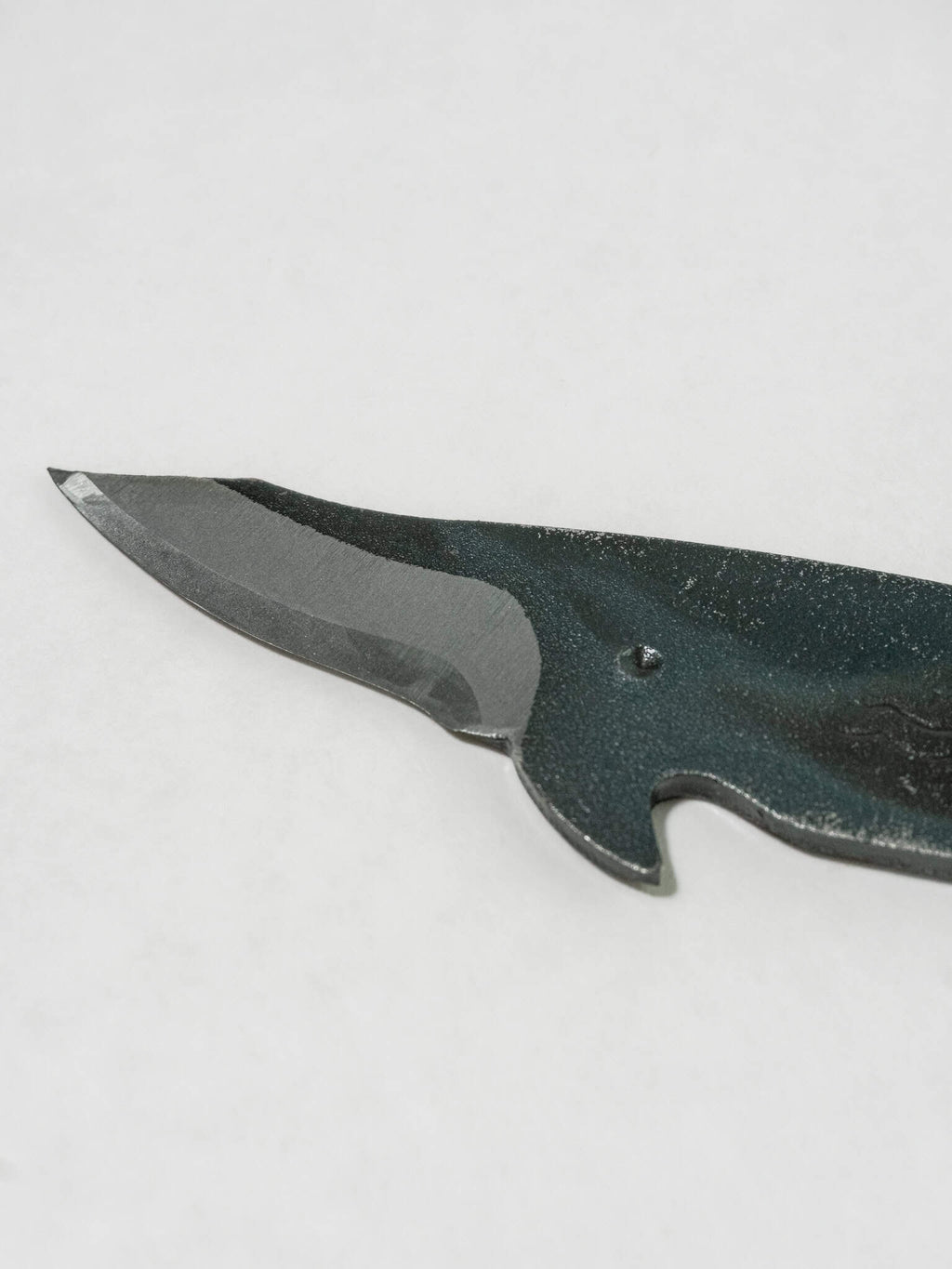 Close up of the blade from the Toru Whale Utility Knife, forged from SK5 steel.