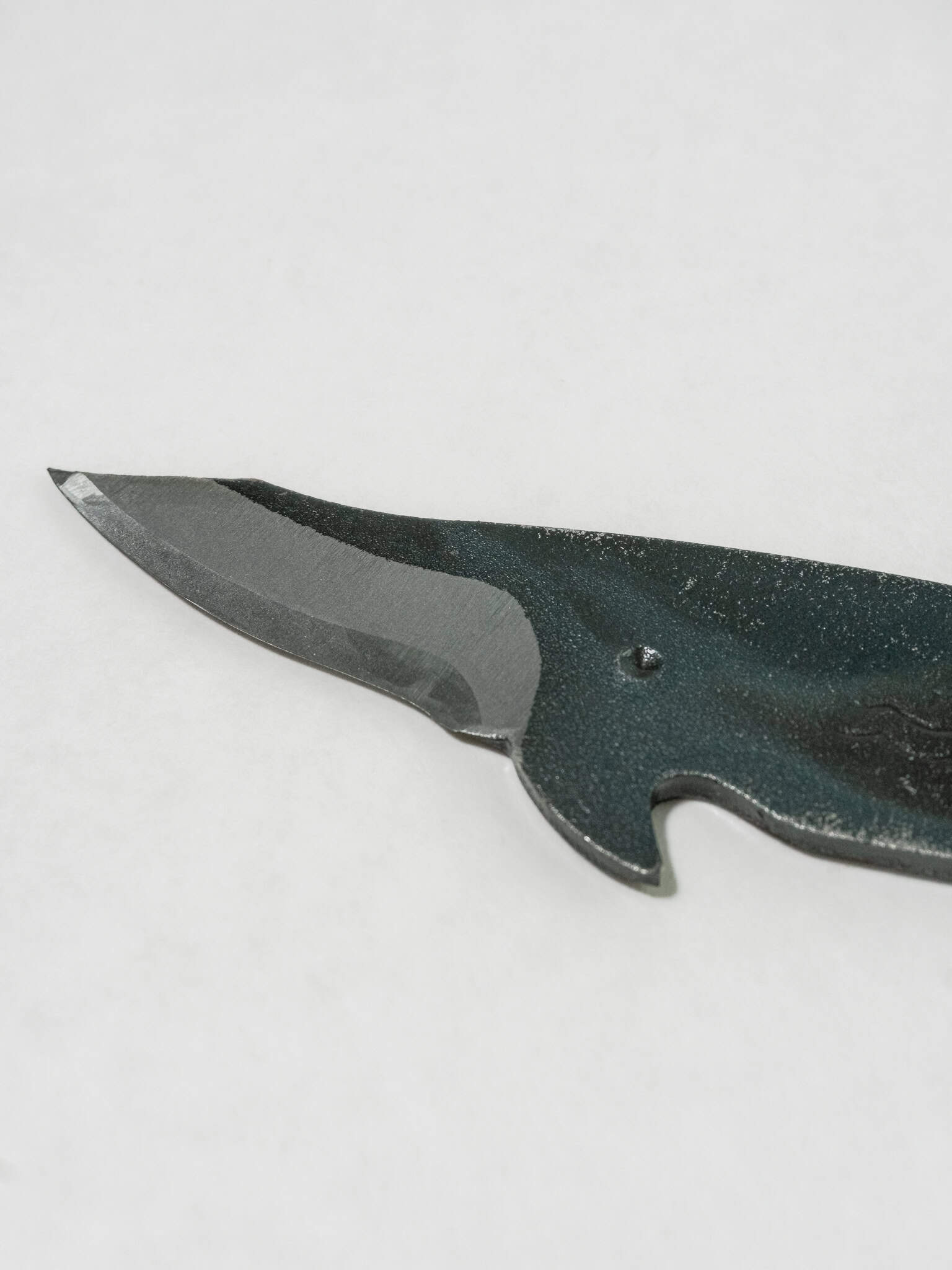 Close up of the blade from the Toru Whale Utility Knife, forged from SK5 steel.